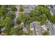 An aerial view shows the home situated in a neighborhood with mature trees lining the streets, creating a peaceful atmosphere at 676 Juneberry Se Ln, Atlanta, GA 30316