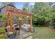 Backyard features pergola with patio furniture and lush lawn at 676 Juneberry Se Ln, Atlanta, GA 30316