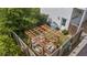 Aerial view of a cozy backyard featuring a charming pergola with seating, surrounded by lush greenery and privacy fencing at 676 Juneberry Se Ln, Atlanta, GA 30316