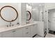 Elegant bathroom features dual sinks, round mirrors, and a spacious glass shower, offering a spa-like experience at 676 Juneberry Se Ln, Atlanta, GA 30316