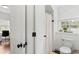 Bright bathroom with a toilet, shower and window, and view of a office creates a simple and functional space at 676 Juneberry Se Ln, Atlanta, GA 30316