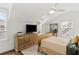 Cozy bedroom features a wooden dresser, ceiling fan, and two windows for lots of natural light at 676 Juneberry Se Ln, Atlanta, GA 30316