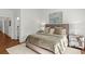 Inviting bedroom features plush bedding, wood floors, and stylish mirrored nightstand, creating a comfortable retreat at 676 Juneberry Se Ln, Atlanta, GA 30316