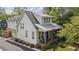Charming home featuring white siding, a metal roof, and inviting front porch seating at 676 Juneberry Se Ln, Atlanta, GA 30316