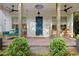 Inviting front porch with swing, rocking chairs, and stylish brick flooring at 676 Juneberry Se Ln, Atlanta, GA 30316