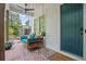 Close-up of the cozy front porch featuring a porch swing and brick flooring at 676 Juneberry Se Ln, Atlanta, GA 30316