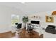 Bright home office features two white desks, dual monitors, and hardwood floors at 676 Juneberry Se Ln, Atlanta, GA 30316