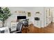 Bright home office features a white desk, dual monitors, hardwood floors, and a doorway at 676 Juneberry Se Ln, Atlanta, GA 30316