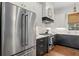 This kitchen features stainless steel appliances, mixed-tone cabinets and under cabinet lighting at 676 Juneberry Se Ln, Atlanta, GA 30316