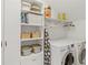Well-organized laundry room features a washer, dryer, and ample storage, designed for efficiency and convenience at 676 Juneberry Se Ln, Atlanta, GA 30316
