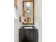 Stylish powder room boasts a dark vanity with marble countertop and a wooden framed mirror at 676 Juneberry Se Ln, Atlanta, GA 30316