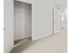 Open bedroom door leads into a bright room, showcasing a closet with wire shelving at 8219 Coldstream Dr, Fairburn, GA 30213