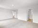 Carpeted main bedroom features neutral walls and two doorways, including one that leads to the bathroom at 8219 Coldstream Dr, Fairburn, GA 30213