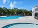 A resort-style swimming pool surrounded by mature trees, offering a serene recreational space at 8219 Coldstream Dr, Fairburn, GA 30213