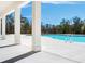 Beautiful view of community pool with deck and white columns with trees and landscaping at 8219 Coldstream Dr, Fairburn, GA 30213