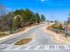 Street view of a new community with well-maintained roads, landscaping, and community signage on a sunny day at 8219 Coldstream Dr, Fairburn, GA 30213