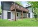 Backyard features a spacious deck, with grass and access to the basement level at 831 Sweet Briar Se Ln, Conyers, GA 30094