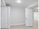 Unfinished basement featuring white walls, recessed lighting, and multiple storage closets at 831 Sweet Briar Se Ln, Conyers, GA 30094