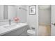 Bathroom featuring a white vanity, modern sink, and neutral walls at 831 Sweet Briar Se Ln, Conyers, GA 30094