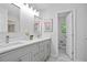Bathroom with double sinks, sleek fixtures, framed mirrors, and marble flooring at 831 Sweet Briar Se Ln, Conyers, GA 30094