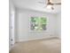 Bright bedroom featuring large window with natural light and a ceiling fan at 831 Sweet Briar Se Ln, Conyers, GA 30094