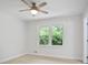 Bedroom with carpet, white walls, and a large window letting in lots of natural light at 831 Sweet Briar Se Ln, Conyers, GA 30094