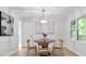 Bright dining room with modern lighting, neutral decor, and a view to the home's deck at 831 Sweet Briar Se Ln, Conyers, GA 30094