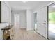 Bright entryway with white walls, wood-look floors, modern table and an exterior door with sidelight at 831 Sweet Briar Se Ln, Conyers, GA 30094
