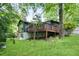Exterior view of the back of the home, featuring a deck, and walkout basement at 831 Sweet Briar Se Ln, Conyers, GA 30094