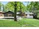 Charming home with a well-manicured front yard, featuring lush green grass and mature trees at 831 Sweet Briar Se Ln, Conyers, GA 30094