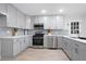 Updated kitchen with modern grey cabinets, stainless steel appliances, and light countertops at 831 Sweet Briar Se Ln, Conyers, GA 30094