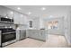 Bright kitchen with stainless appliances, light countertops, and updated gray cabinets at 831 Sweet Briar Se Ln, Conyers, GA 30094