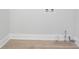 Laundry room hookups with white trim and wood-look floors at 831 Sweet Briar Se Ln, Conyers, GA 30094