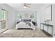 Bedroom featuring light colored walls, modern ceiling fan, and a private balcony entrance at 831 Sweet Briar Se Ln, Conyers, GA 30094