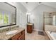 Bright bathroom with double sinks, granite countertop, and a glass enclosed shower at 1446 Wilford Ne Dr, Atlanta, GA 30319