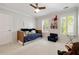 Bright bedroom with plantation shutters, a daybed, and a ceiling fan at 1446 Wilford Ne Dr, Atlanta, GA 30319