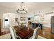Open-concept dining room with hardwood floors, chandelier, and views into kitchen and living room at 1446 Wilford Ne Dr, Atlanta, GA 30319