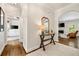 Hallway with hardwood floors leading to living room and study featuring stylish table with decor accents at 1446 Wilford Ne Dr, Atlanta, GA 30319