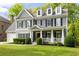 Beautiful two-story home with gray siding, black shutters, dormer windows and well-manicured landscaping at 1446 Wilford Ne Dr, Atlanta, GA 30319
