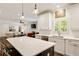 Open kitchen features white cabinets and a center island with a granite countertop at 1446 Wilford Ne Dr, Atlanta, GA 30319