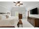 Spacious main bedroom with a large bed, a seating bench, and two large windows at 1446 Wilford Ne Dr, Atlanta, GA 30319