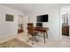 Bright home office features a desk, comfortable chair, wall-mounted TV, and an adjacent bathroom at 1446 Wilford Ne Dr, Atlanta, GA 30319