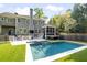 Inviting backyard featuring a large swimming pool, outdoor kitchen, seating, and well-maintained lawn at 1446 Wilford Ne Dr, Atlanta, GA 30319
