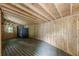 Unfinished basement space with wooden floor, exposed beams, and bright window at 3311 Lavista Dr, Hapeville, GA 30354