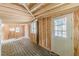 Unfinished basement with light wood walls and a door to the exterior at 3311 Lavista Dr, Hapeville, GA 30354