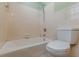 Clean white tiled bathroom with bathtub and toilet at 3311 Lavista Dr, Hapeville, GA 30354