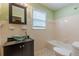 Well-lit bathroom with classic vanity, bathtub and tile walls at 3311 Lavista Dr, Hapeville, GA 30354