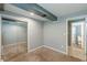 Bedroom with carpet, closet, and bathroom featuring tiled floors, toilet, and walk-in shower with glass doors at 3311 Lavista Dr, Hapeville, GA 30354