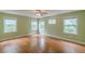 Spacious bedroom with hardwood floors, soft green walls and natural lighting at 3311 Lavista Dr, Hapeville, GA 30354