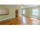 Large bedroom featuring hardwood floors, many windows and soft green walls at 3311 Lavista Dr, Hapeville, GA 30354